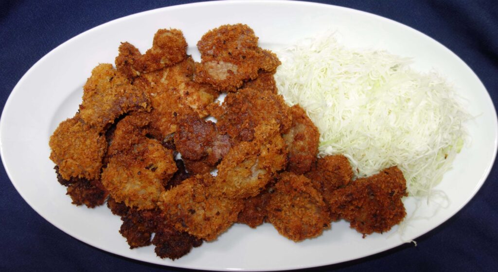皿に盛られた一口カツと千切りキャベツ
