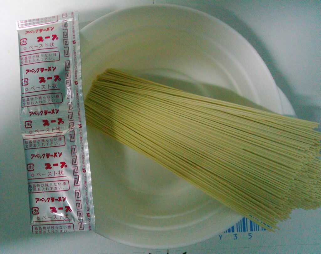 皿に盛られた乾麺とアベックラーメンのスープ